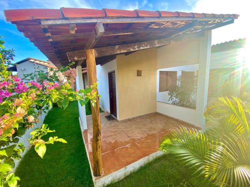 a view of a house with a pergola at Pousada pedra da baleia in São Miguel do Gostoso