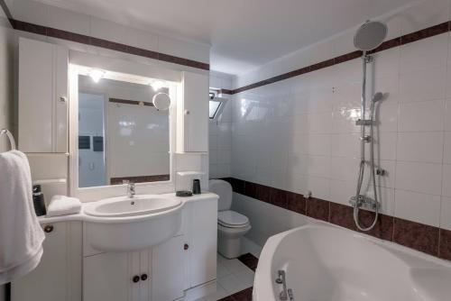 a bathroom with a sink and a toilet and a shower at Villa Anna Nina in Gouves - 3BD Retreat - Sleeps 8 in Kato Gouves
