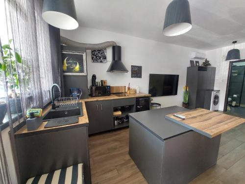 cocina con encimera, fregadero y fogones en Best City Green, en Craiova