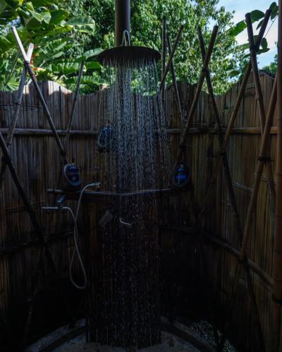 a shower in a backyard with a fence at QASA Hotel and Retreat Center in San Luis