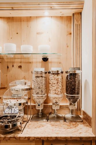 a display case with wine glasses on a shelf at Hotel Kohlpeter in Salzburg