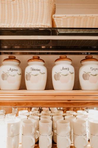 a shelf filled with white mugs and bowls at Hotel Kohlpeter in Salzburg