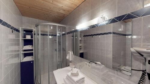 a bathroom with a shower and a sink and a tub at Hotel - Restaurant - Sonnblick in Heiligenblut