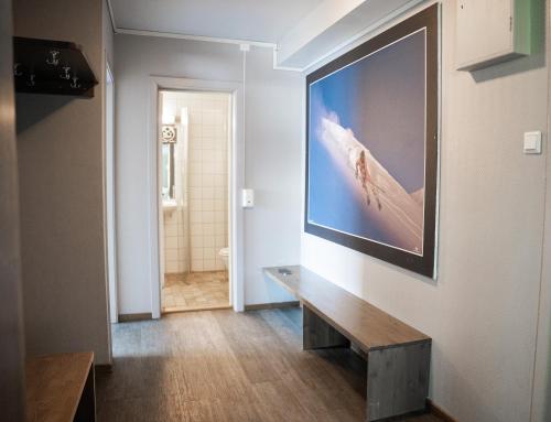 a living room with a large flat screen tv on a wall at Hemsedal Cafe Skiers Lodge in Hemsedal