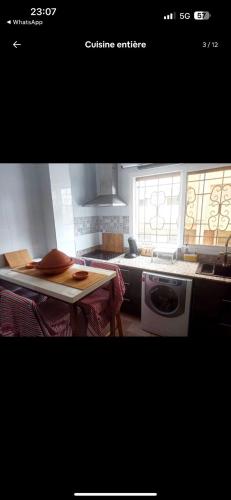 a kitchen with a table and a stove top oven at Meyssa's Paradise in Tangier