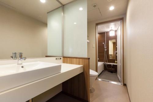 a bathroom with a sink and a toilet at Matsuyama Tokyu REI Hotel in Matsuyama