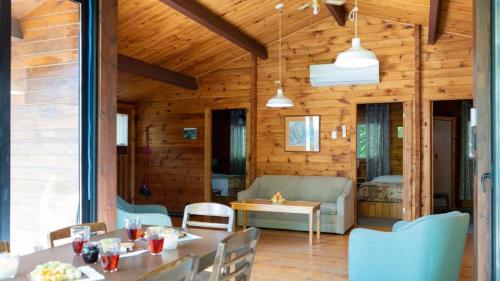 a living room with a table and a couch at Lake Muskoka 3-bdrm Cottage - Pier 100 #70 in Port Carling