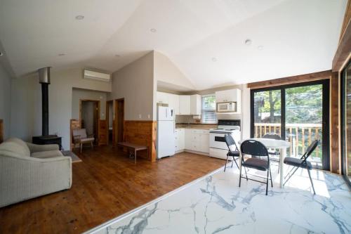 卡灵港Lake Muskoka Deluxe 2-bdrm Cottage - Pier 100 #60的带沙发、桌子和椅子的客厅