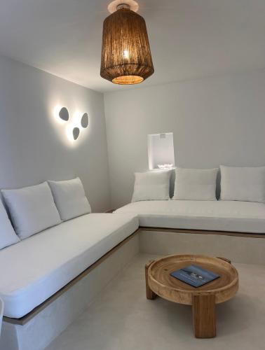 a living room with two beds and a coffee table at Entice Residence in Kóstos