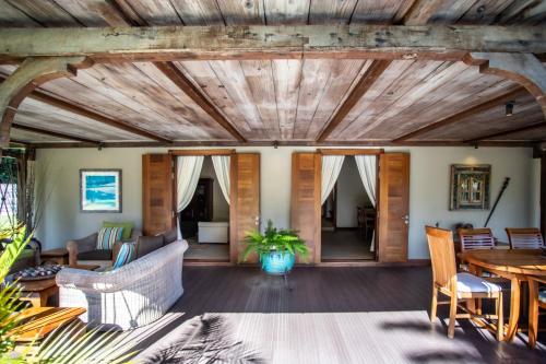 a living room with a wooden ceiling at Kitesurf Paradise at Le Morne - Pool, Garden, Views in Le Morne