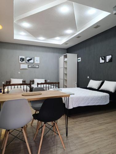 a bedroom with a bed and a table and chairs at Apartment Sekulovski in Ohrid