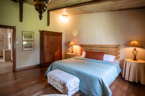 a bedroom with a large bed and two lamps at Kitesurf Paradise at Le Morne - Pool, Garden, Views in Le Morne
