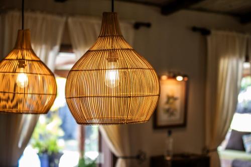 three lit up lamps hanging from the ceiling at Kitesurf Paradise at Le Morne - Pool, Garden, Views in Le Morne