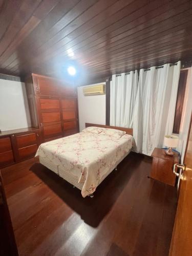 a bedroom with a bed in a wooden room at Chalé em Barreirinhas com Piscina e Cozinha - Refúgio da Vicky nos Lençóis Maranhenses in Barreirinhas