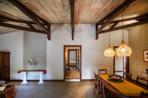 a dining room with wooden ceilings and a table at Kitesurf Paradise at Le Morne - Pool, Garden, Views in Le Morne