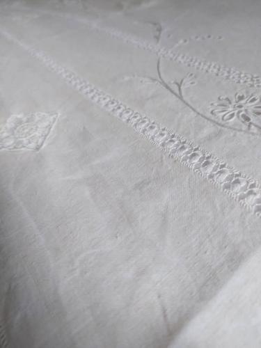 a close up of a white embroidery on a bedsheet at Casale Filieri in SantʼElia Fiumerapido