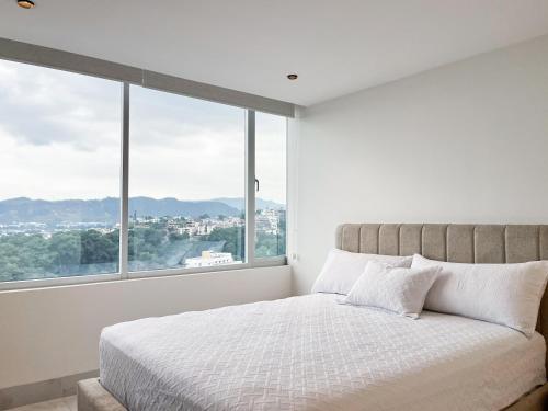 Postel nebo postele na pokoji v ubytování NEW! Suite,Piscina de lujo, GYM, WiFi, Tv en Guayaquil zona ejecutiva