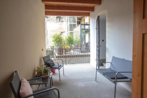 a room with chairs and a balcony with a fence at Da ME in Aosta