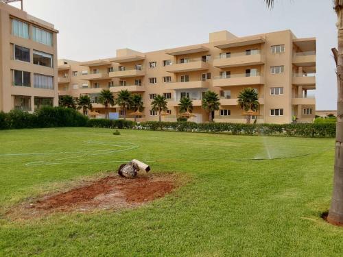 a large grassy field in front of a large building at Evasion Prince 1 in Sidi el Haj Bou Derbala