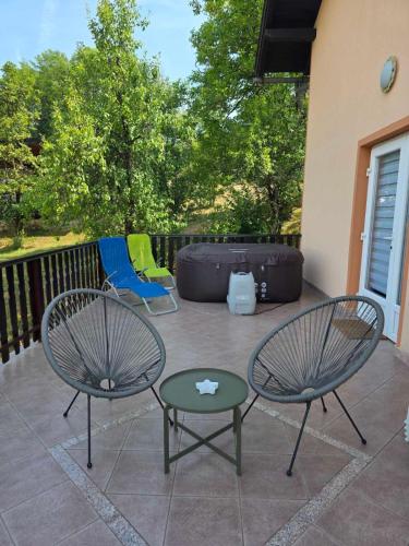 two chairs and a table on a patio at Kuca za odmor Juraj - Apartmani Barsic in Duga Resa
