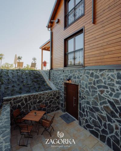 a house with a stone wall and a wooden door at Boutique Villa Zagorka in Stubicke Toplice