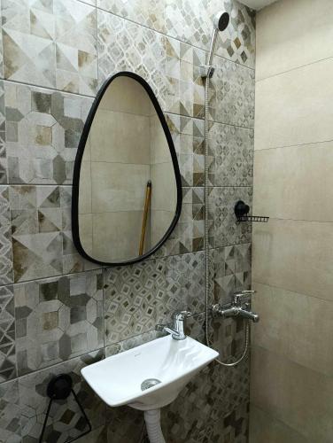 a bathroom with a sink and a mirror on the wall at Apartment Sekulovski in Ohrid