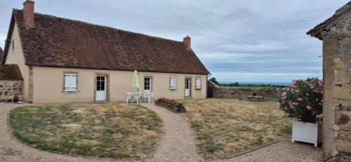 a small house with a yard and a building at L'Orée de Tronçais in Le Plaix
