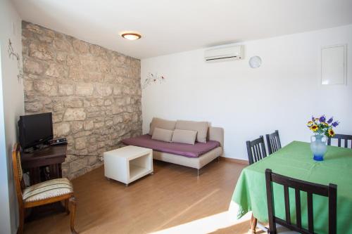 a living room with a couch and a table at Apartment Pogled na luku in Cres