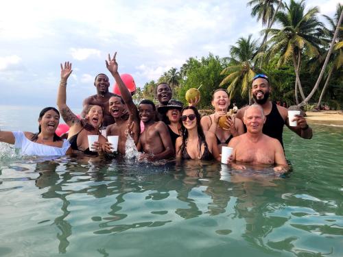 a group of people standing in the water at Hostel 23 in Las Terrenas