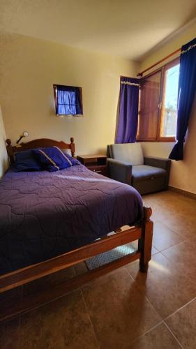 En eller flere senge i et værelse på Amanecer en los colorados