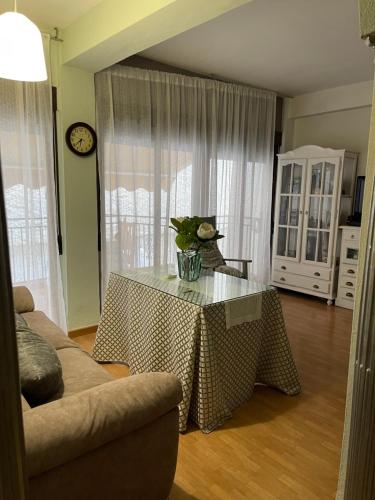 a living room with a table with a vase on it at Piso mar in Salobreña