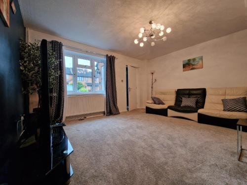 a living room with a couch and a window at A spare room in a quite cul de sac in New Bilton