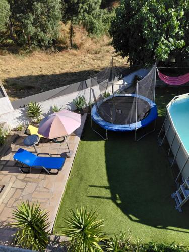 an overhead view of a backyard with a pool and an umbrella at Quinta da Àgua in Torre de Moncorvo