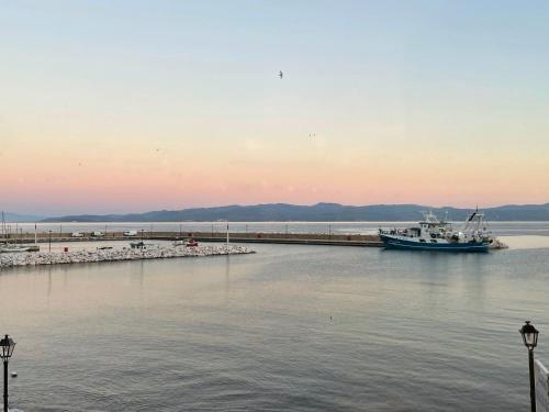 a boat is docked at a dock in the water at Delfinia Studios in Platanias