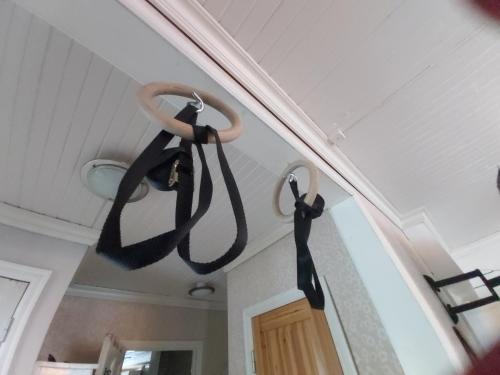 two black ropes hanging from the ceiling of a room at Rooms in a big wooden home, kotimajoitus, homestay in Muonio