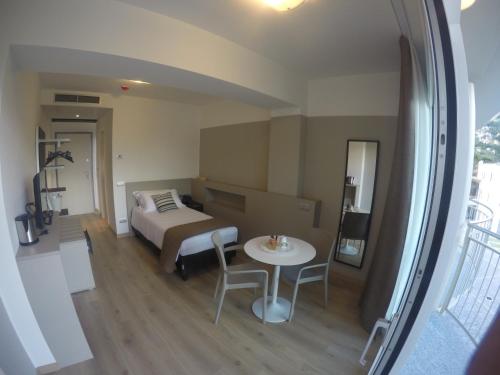 a small room with a bed and a table at Hotel Vischi in Domaso