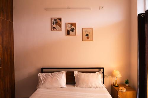 a bedroom with a bed with white pillows at Modern Apartment with Balcony - Electronic City in Bengaluru