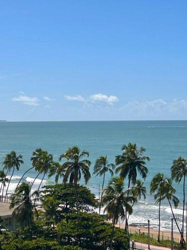 a view of a beach with palm trees and the ocean at Apto recém-inaugurado, com vista mar, a alguns passos da praia e do melhor shopping de Maceió! in Maceió