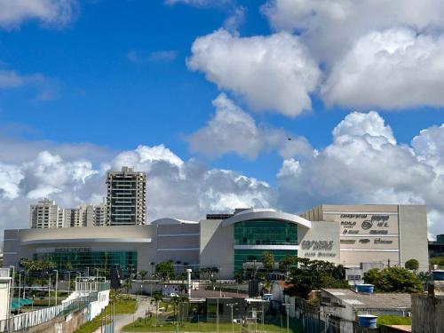 a large building with clouds in the sky at Apto recém-inaugurado, com vista mar, a alguns passos da praia e do melhor shopping de Maceió! in Maceió