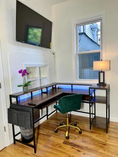 an office with a desk and a chair and a television at Hotel-Style, No Host, Professionally Managed ID255 in Jersey City