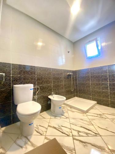 a bathroom with a toilet and a sink at Maison Hijaz in Oulad Akkou