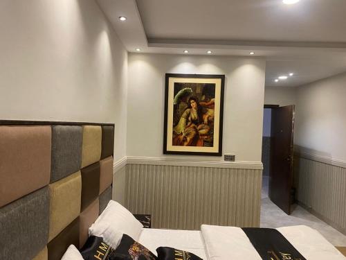 a bedroom with a painting on the wall and a bed at Hotel Milton islamabad in Islamabad