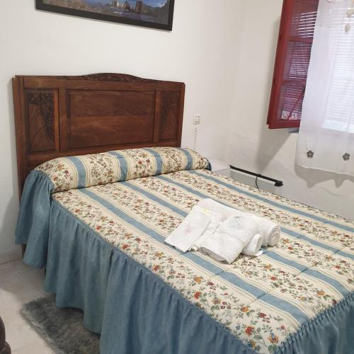a bed with two pillows on top of it at Casita de Aldea in Sotrondio