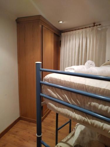 a room with two bunk beds and a cabinet at Hotel Peña Pandos in Felechosa
