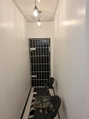 a room with a chair and a black gate at Cozy Home Away in Beterverwagting
