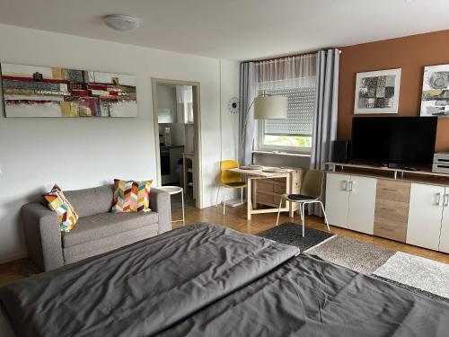 a bedroom with a bed and a living room at Haus - Sonneck in Schonwald im Schwarzwald