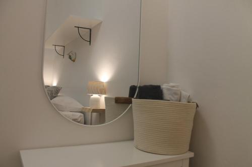 a mirror on a white wall in a room at Dioniso Affittacamere in Conversano