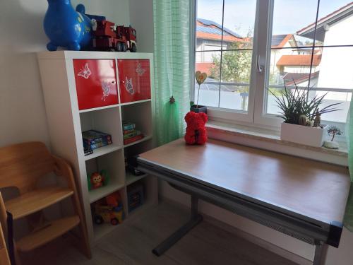 a wooden desk in a room with a window at 4 Zimmer Wohnung im 1. Stock in Traunreut