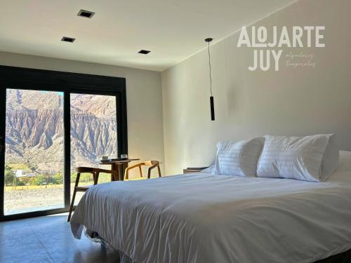 En eller flere senge i et værelse på Altos de la Quebrada II