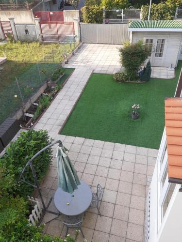 an aerial view of a patio with a bench in a garden at Home OKSY in Cavalcaselle